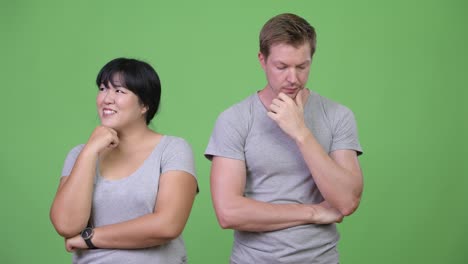 young multi-ethnic couple thinking differently together
