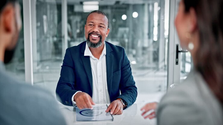 Smiling Businessman Shakes Hands During a Corporate Meeting