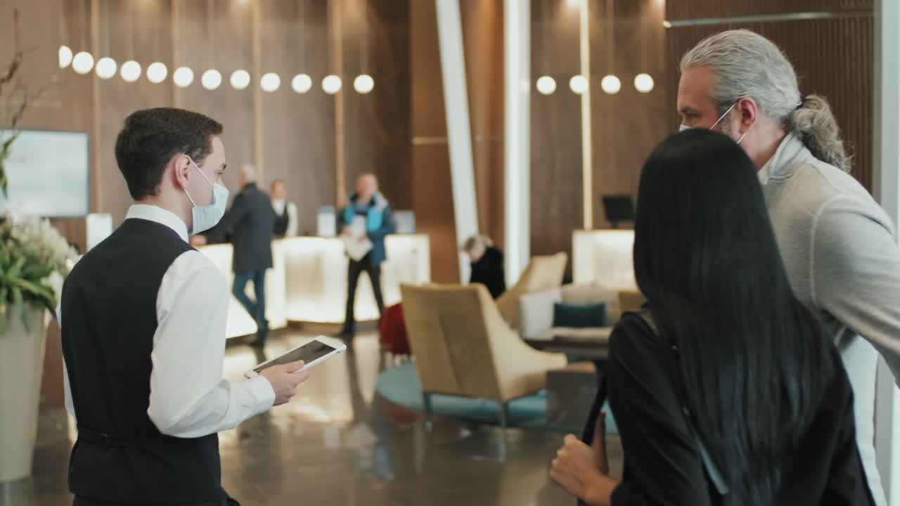 Hotel Manager Welcoming Guest Couple