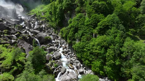 aerial flying towards base of the foroglio waterfall located in the bavona valley