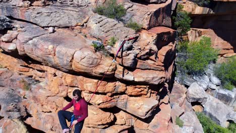 male highliner walkng on a rope over rocky mountains 4k