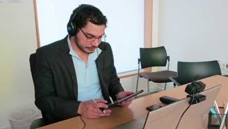 analyzing performance data: man with tablet in call