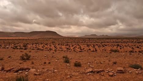 Tunisia-desert-landscape-and-cloudy-dramatic-sky-seen-from-car-passenger-point-of-view