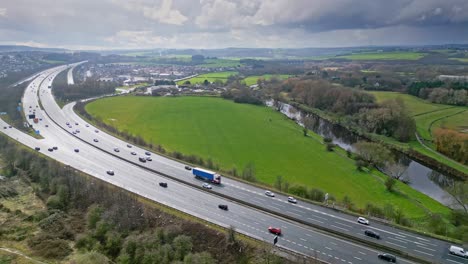 Aerial-drone-cinematic-video-footage-of-the-M1-Motorway-near-the-city-of-Wakefield,-West-Yorkshire,-UK