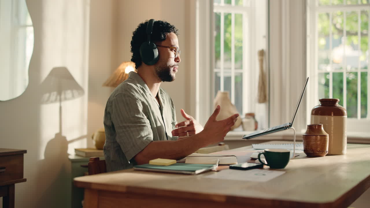 Man in Headphones on Video Call at Home Office Desk