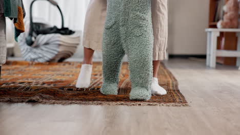 mother helping baby learn to walk