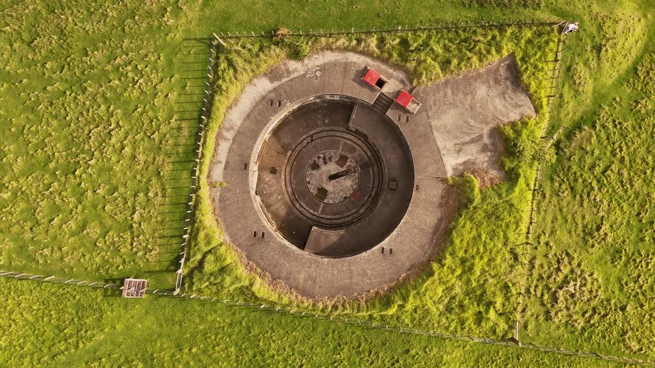 Top-down drone footage flying upward over Stony Batter, a Heritage 1–listed WWII coastal defence fortress on the eastern end of Waiheke Island, New Zealand