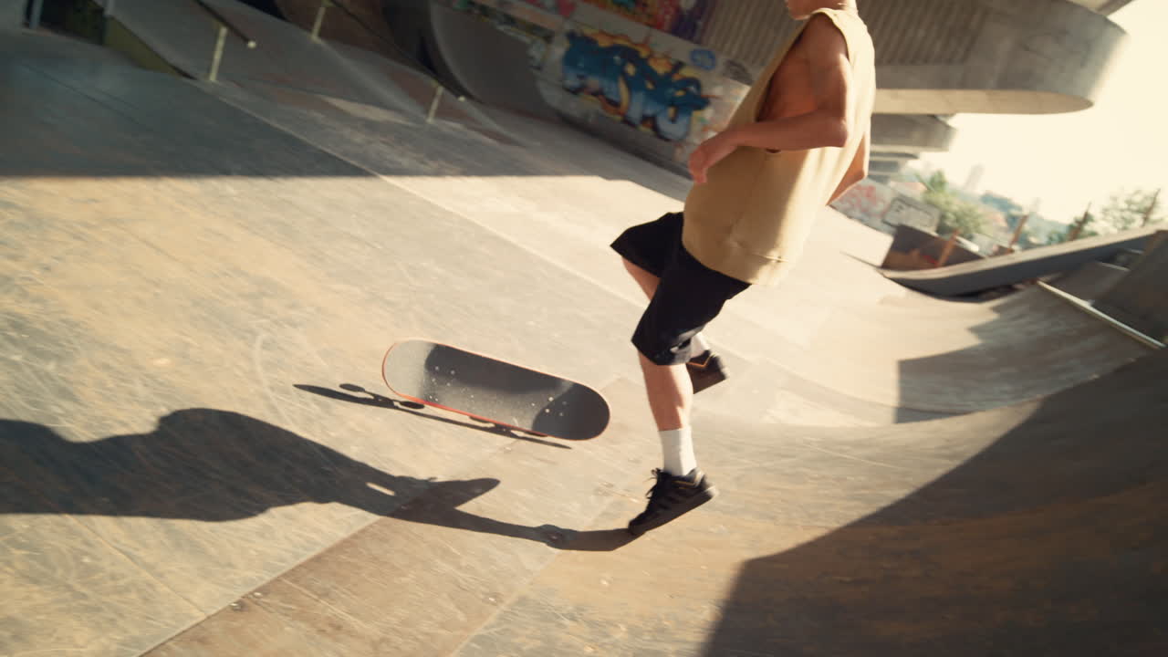 적극적인 스케이트보더가 스케이트파크의 램프에서 트릭을 실패합니다. 극단적인 남자의 라이프 스타일입니다.