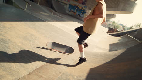 active skateboarder failing trick on ramp at skate park. extreme man lifestyle.