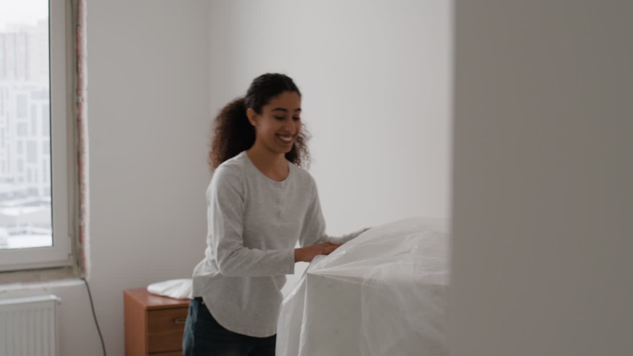 Happy Couple Moving into a New Apartment and Assembling Furniture