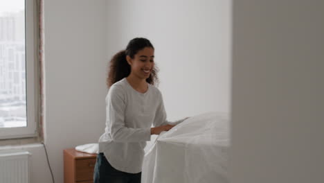 happy couple moving into a new apartment and assembling furniture