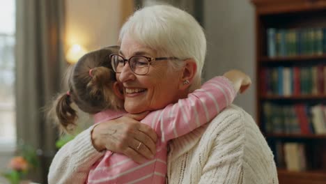 loving grandchild embracing and comforting her grandmother at home