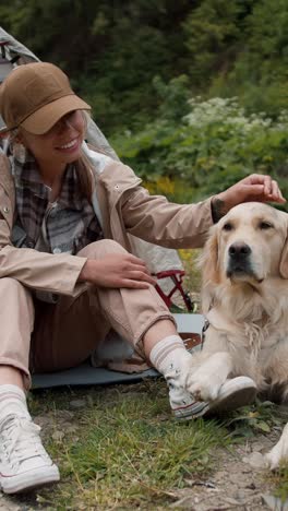 woman and her dog enjoying a camping trip