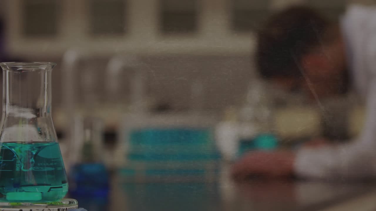 Man leaning over bench, frames unfolding and teal flask, formulas appearing and showing math in lab