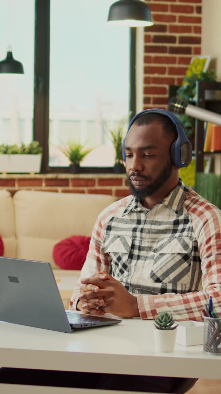 Vertical video: Businessman attending online videoconference meeting