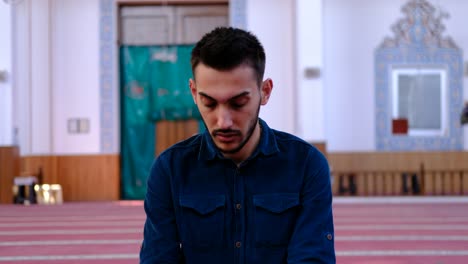 man turning his head during prayer in mosque 1