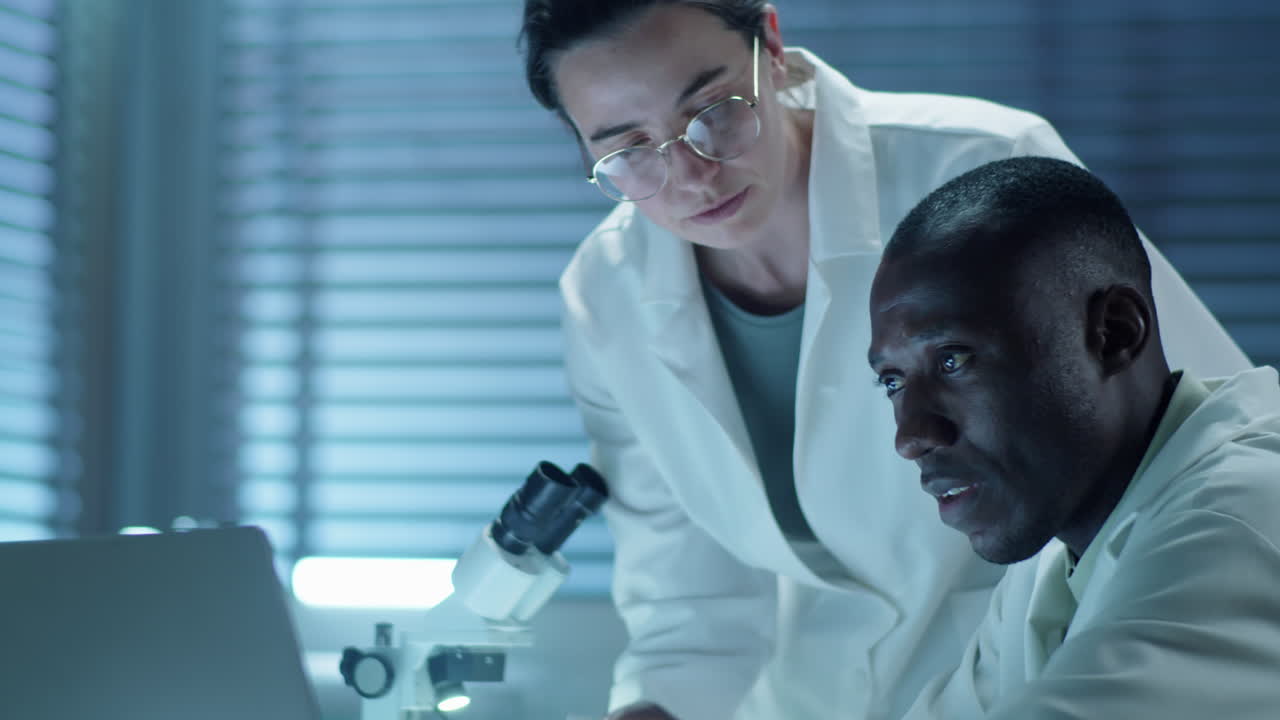 Multiethnic Scientists Working on Laptop in Laboratory