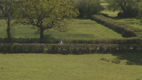 Couple-Cycling-Down-Countryside-Lane-in-Springtime