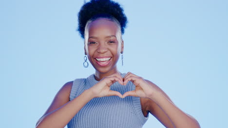 happy, heart and face of a black woman in a studio