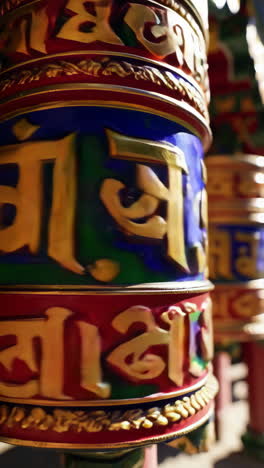 colorful prayer wheels in a buddhist temple
