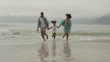 family enjoying free time by the sea