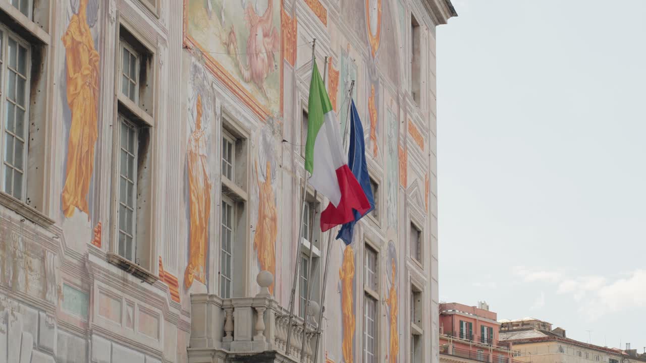 Historic building with flags, depicting the vibrant culture of Genoa, Liguria