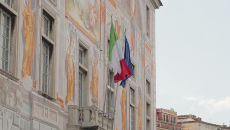 historic building with flags, depicting the vibrant culture of genoa, liguria