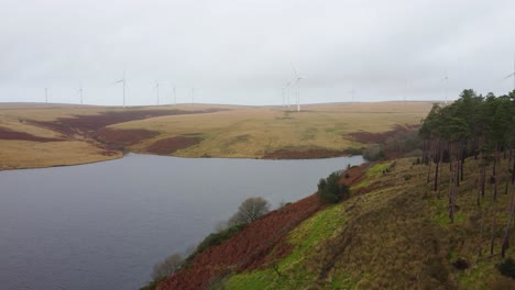 wind turbines on hill next to lliw reservoir in rural wales uk - aerial drone shot 4k