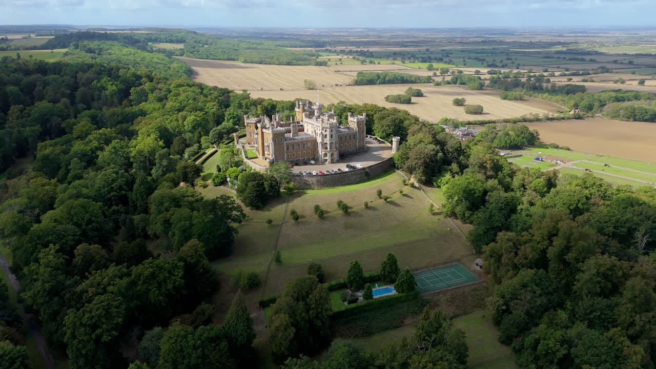 Aerial perspective of historic fortress dominating countryside skyline with green fields and rolling hills in rural United Kingdom