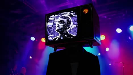 person with tv head at concert