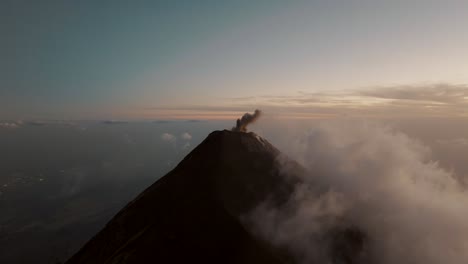 fuego volcano erupting ash during sunset in guatemala