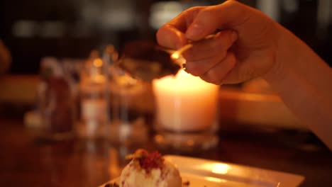 Beautiful-blond-woman-eating-chocolate-brownie-with-icecream-at-luxury-restaurant