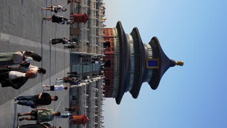 tourists at hall of prayer for good harvests on sunny day, beijing, china. handheld, vertical