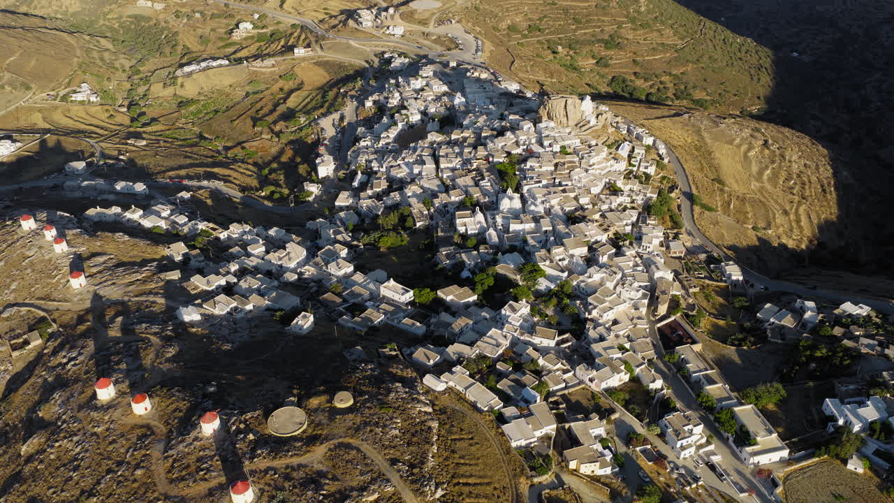 Aerial view of Chora Amorgos and traditional windmills at dawn, Luxury cultural destination
