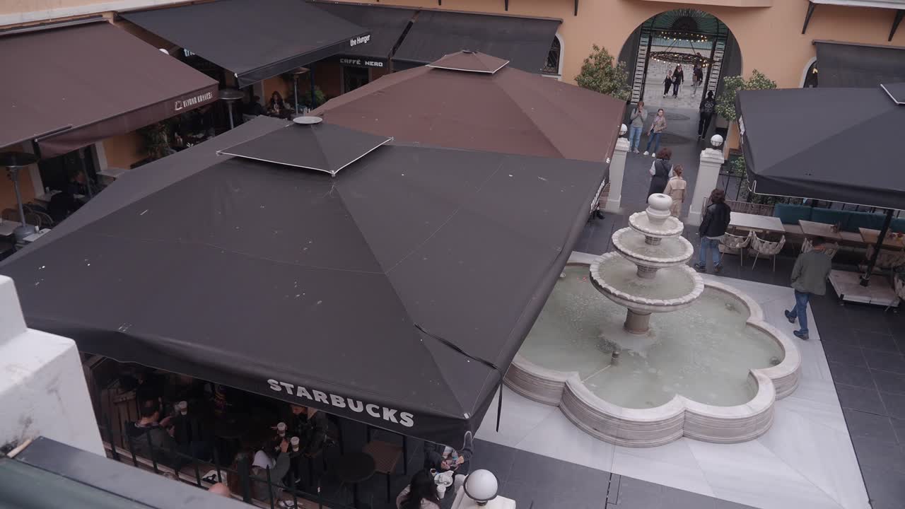 Outdoor Cafe with Fountain in a City Square