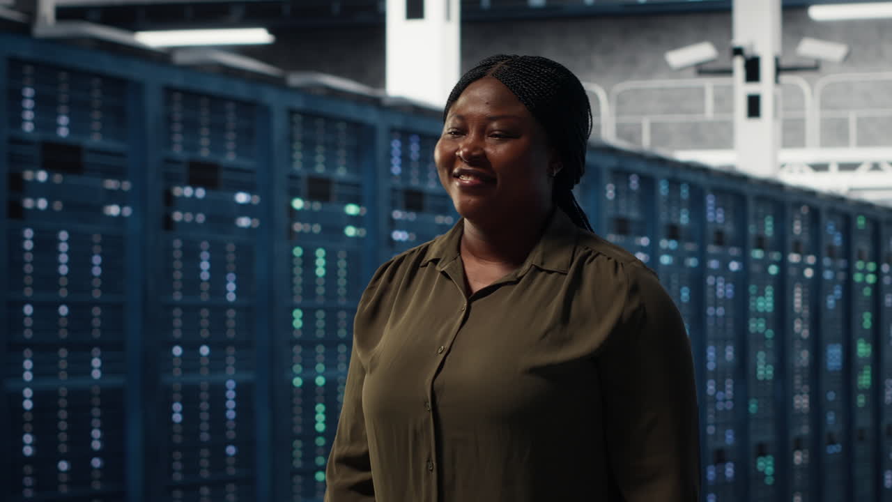 Portrait of smiling admin walking in data center, overseeing IT infrastructure