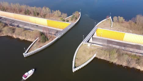 aerial of boat passing over waterbridge aqueduct in veluwemeer, netherlands