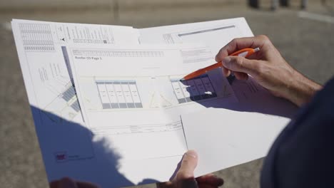 detailed view of roofing blueprints highlighting plans for solar shingle installation.