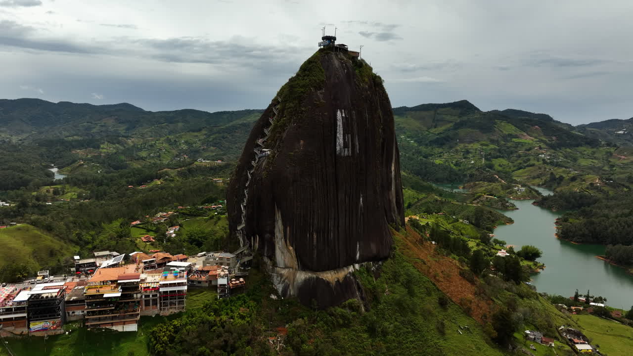 Aerial view orbiting the El Pe&ntilde;&oacute;n de Guatap&eacute; rock, in cloudy Antioquia, Colombia