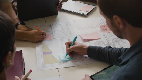 business meeting: team analyzing data and documents