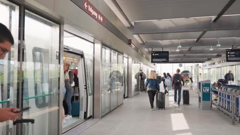 tourists with bags and luggage at international airport terminal, denmark