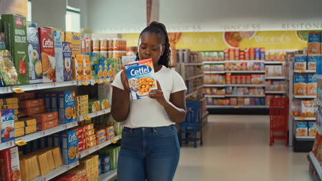 woman shopping and reading product labels in a supermarket