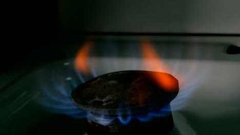 fire from old burner stove top, in domestic kitchen for cooking with flames propane gas or methane burning.