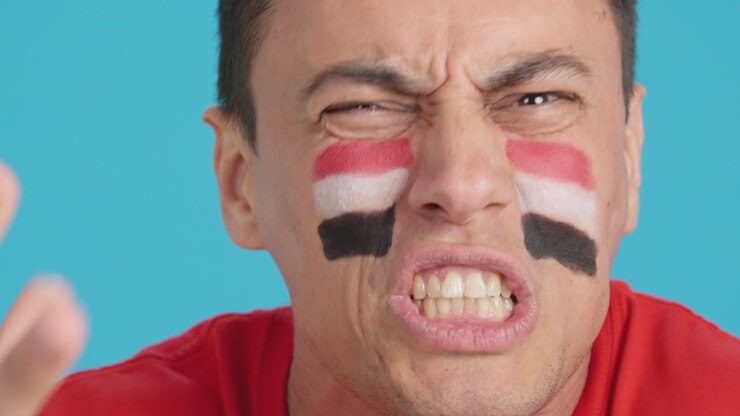 Man with egyptian national flag upset with a referee