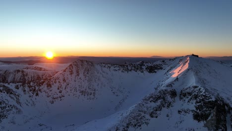 Drone-shot-of-Musala-peak-during-sunrise,-Bulgaria,-Rila-mountain,-highest-peak-on-the-Balkans,-golden-hour,-blue-hour