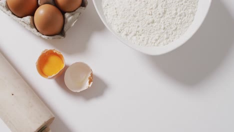 video of baking ingredients and tools lying on white surface