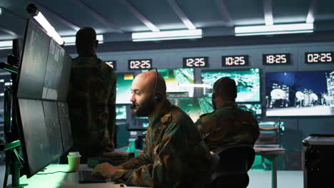 soldier solving tasks in military hq base, gathering information on enemy troops