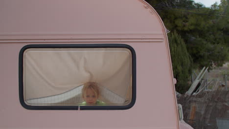 a girl is looking out of the window in a van