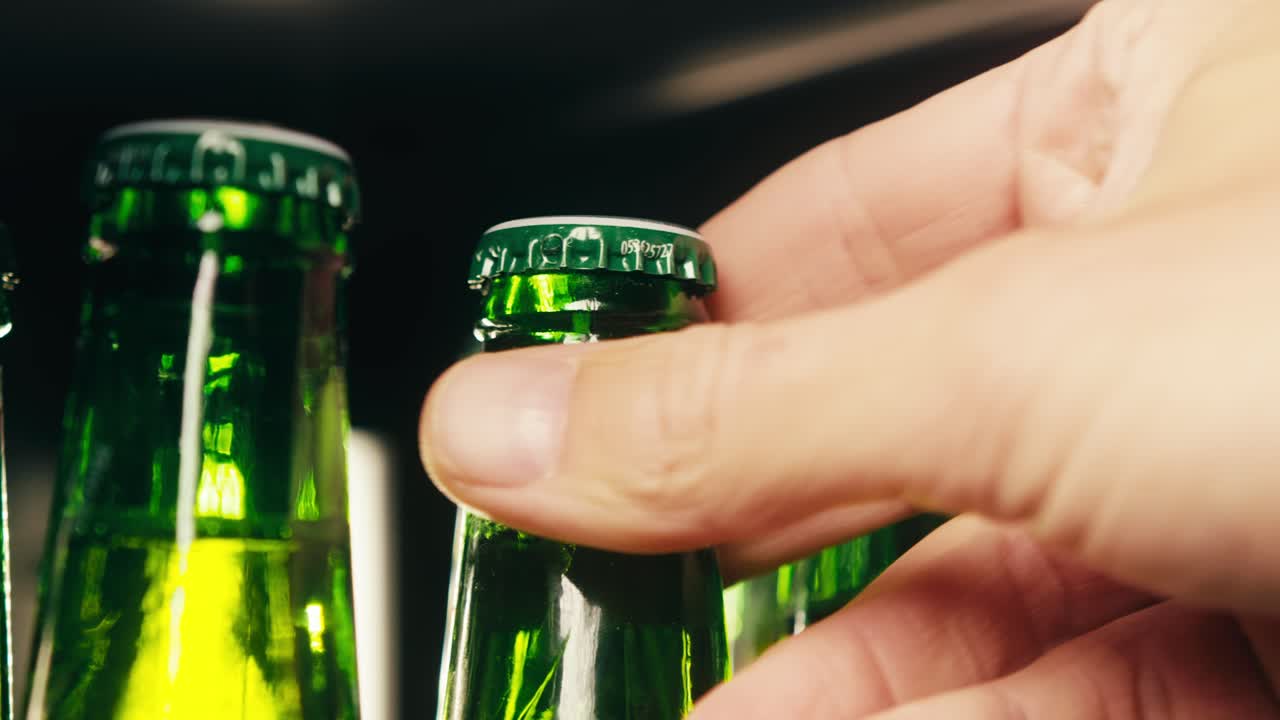 Row of beer bottles in fridge, shop or hotel, cold lager craft german beer or cider, shop supermarket or wine cooler close up.