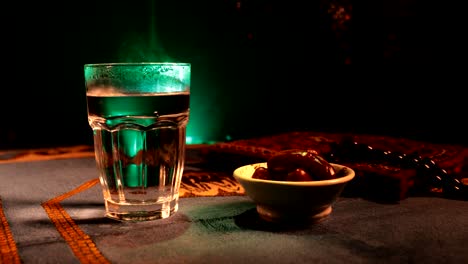 water and dates. iftar is the evening meal. slider view of decoration ramadan kareem holiday. festive greeting card, invitation for muslim holy month ramadan kareem. dark background. selective focus